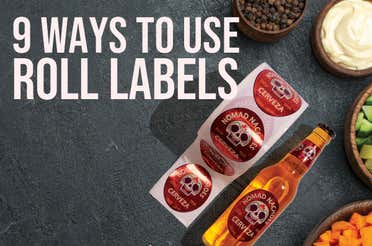 9 Ways To Use Roll Labels text on a grey slate table with bowls of condiments and a bottle of soda. A roll label with the brand Nomad Nachos is on the table beside the soda with the same branded label.